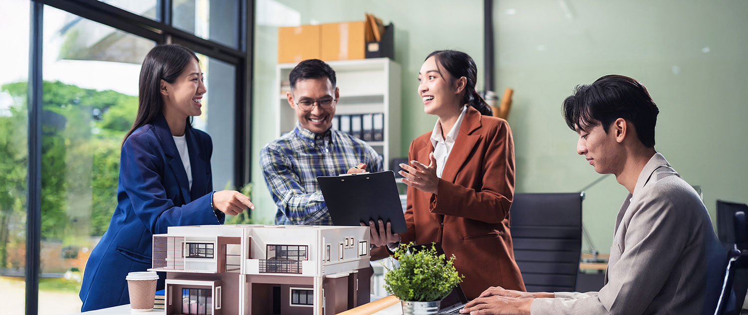 Four real estate professionals discussing around a table